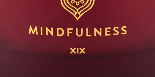 Close-up: the letters XIX under MINDFULNESS instead of the brand mark