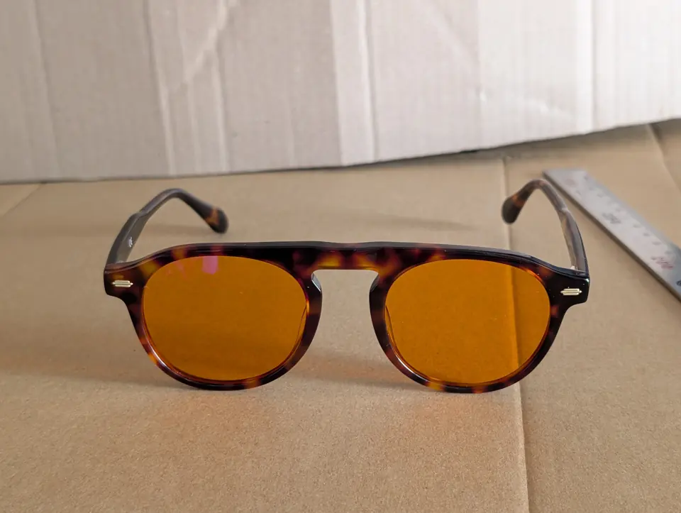 Front view of Mentor glasses photographed on cardboard.