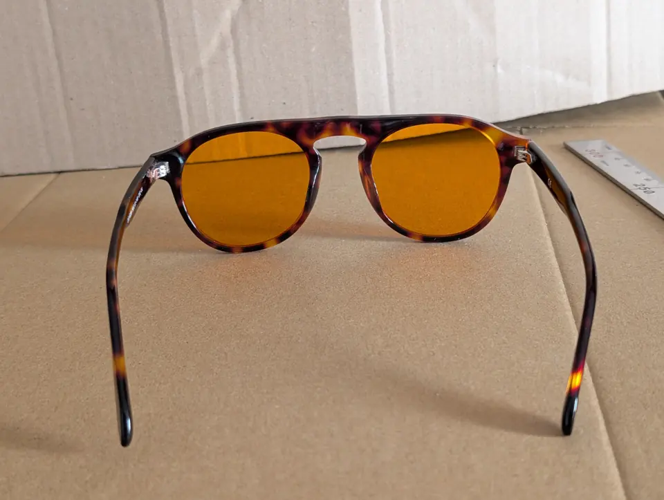 Rear view of Mentor glasses on cardboard.