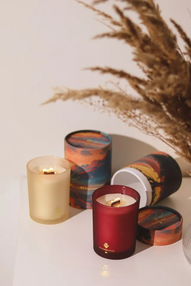 Phone photo: lit candles with tubes and pampas grass